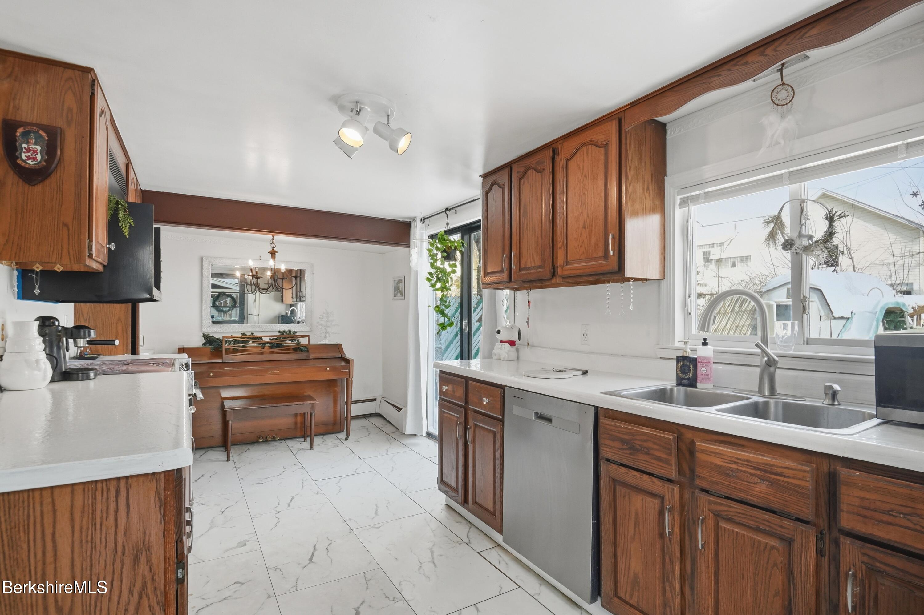 9 Lincoln Street Pittsfield, MA 01201 - Photo 11 of 44 a kitchen with kitchen island granite countertop a sink dishwasher stove and cabinets