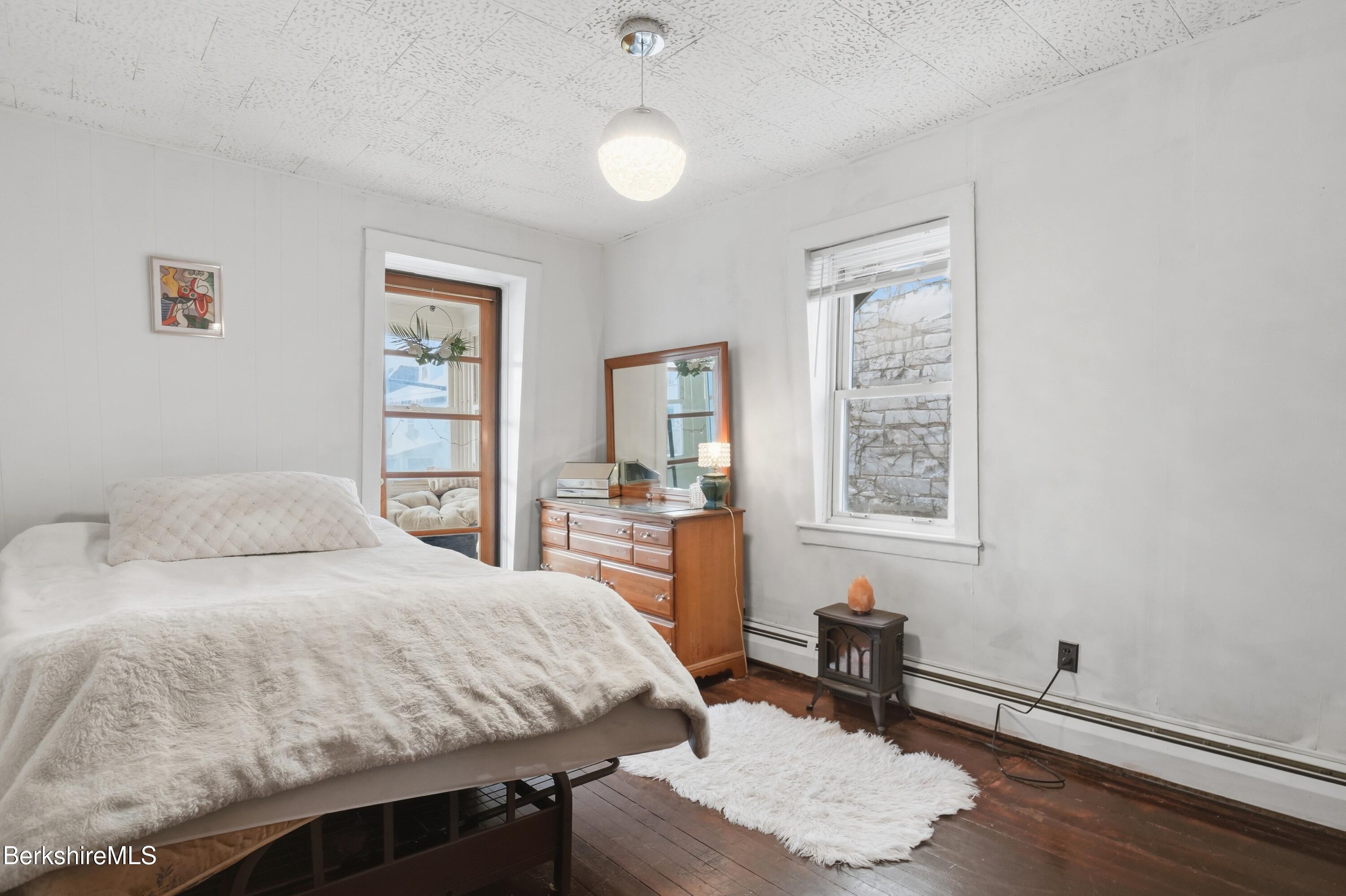 9 Lincoln Street Pittsfield, MA 01201 - Photo 28 of 44 a bedroom with a bed and a table in it