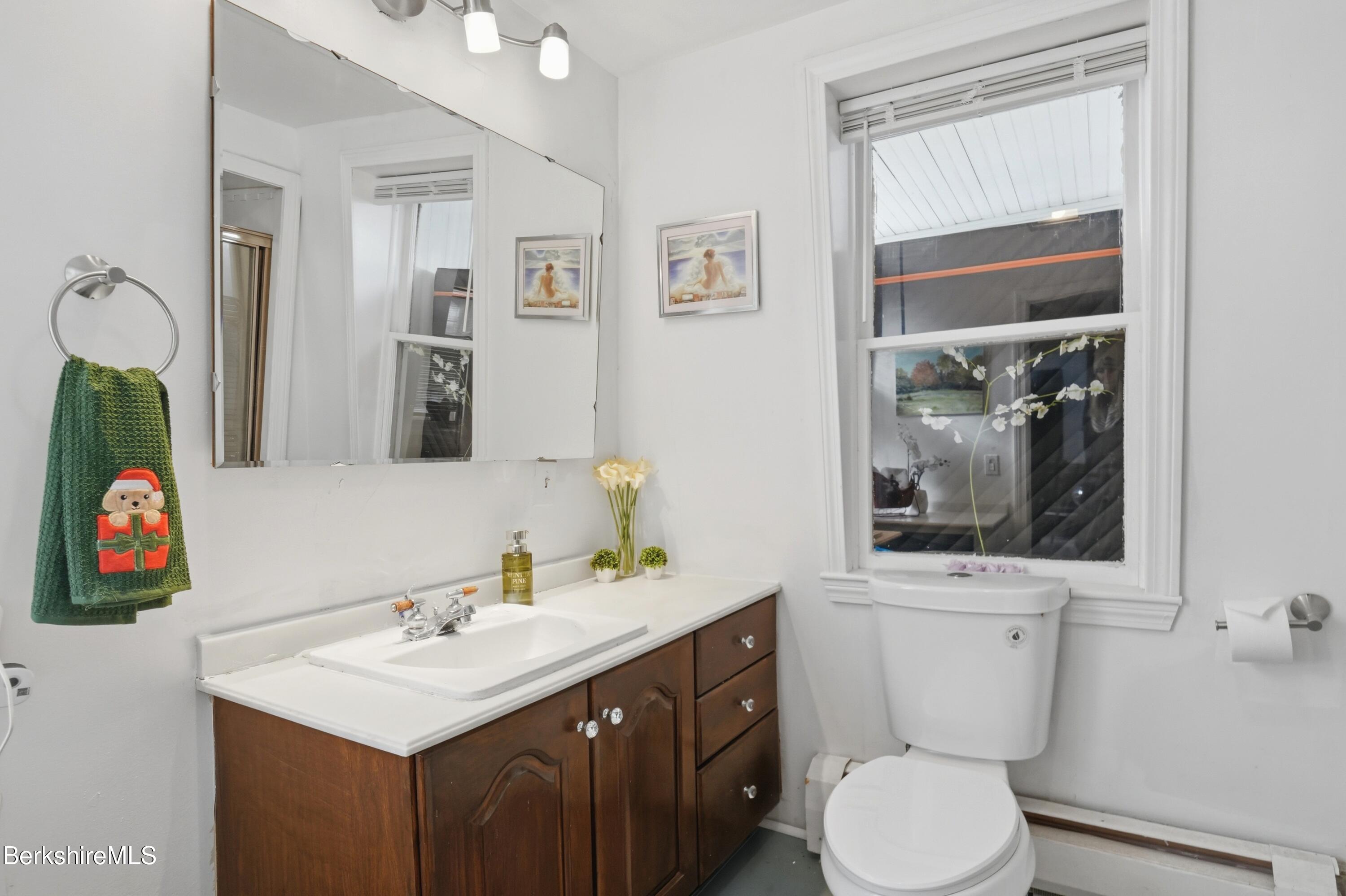 9 Lincoln Street Pittsfield, MA 01201 - Photo 31 of 44 a bathroom with a sink vanity mirror and toilet