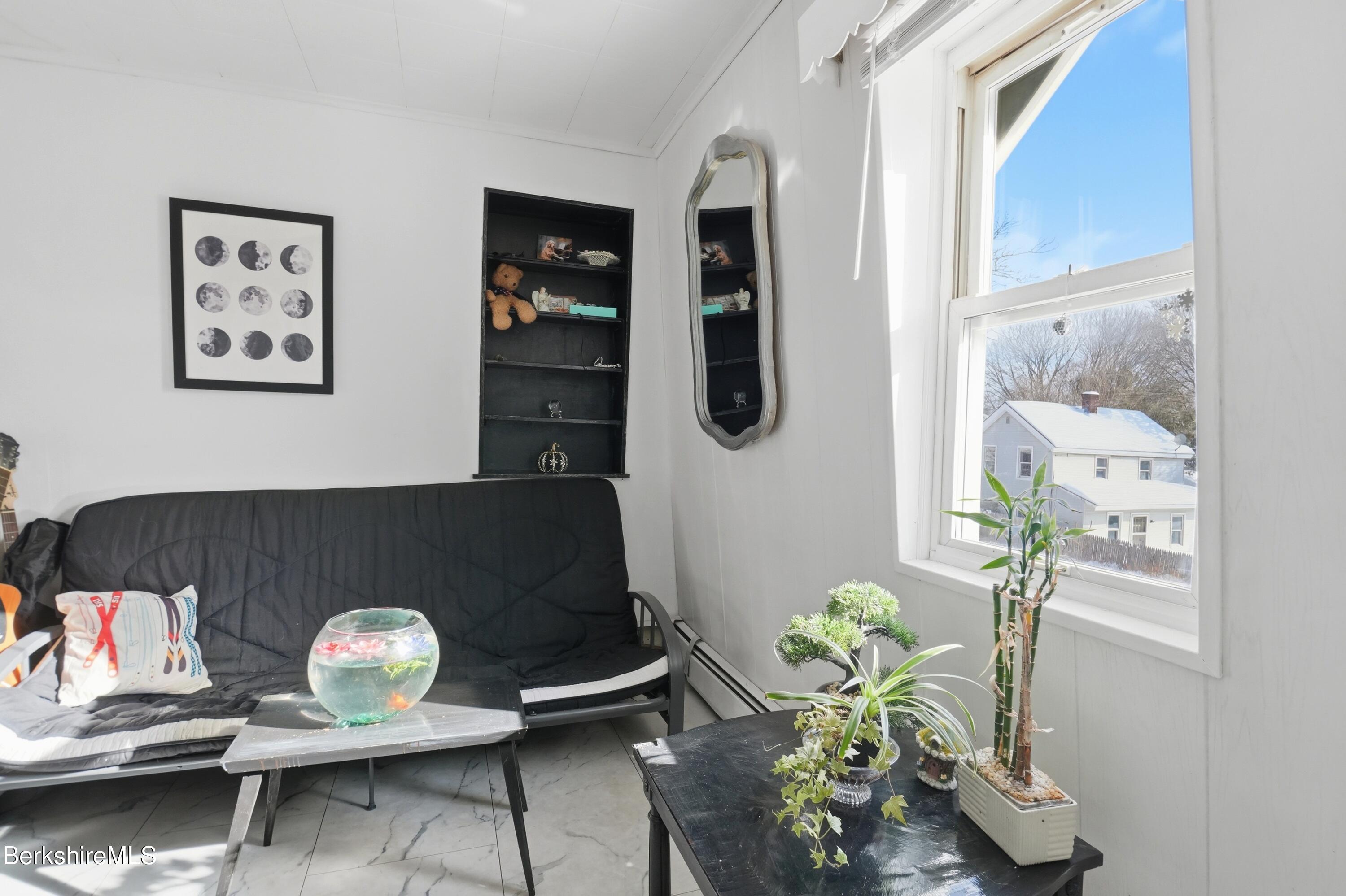 9 Lincoln Street Pittsfield, MA 01201 - Photo 42 of 44 a table with a couch and a potted plant