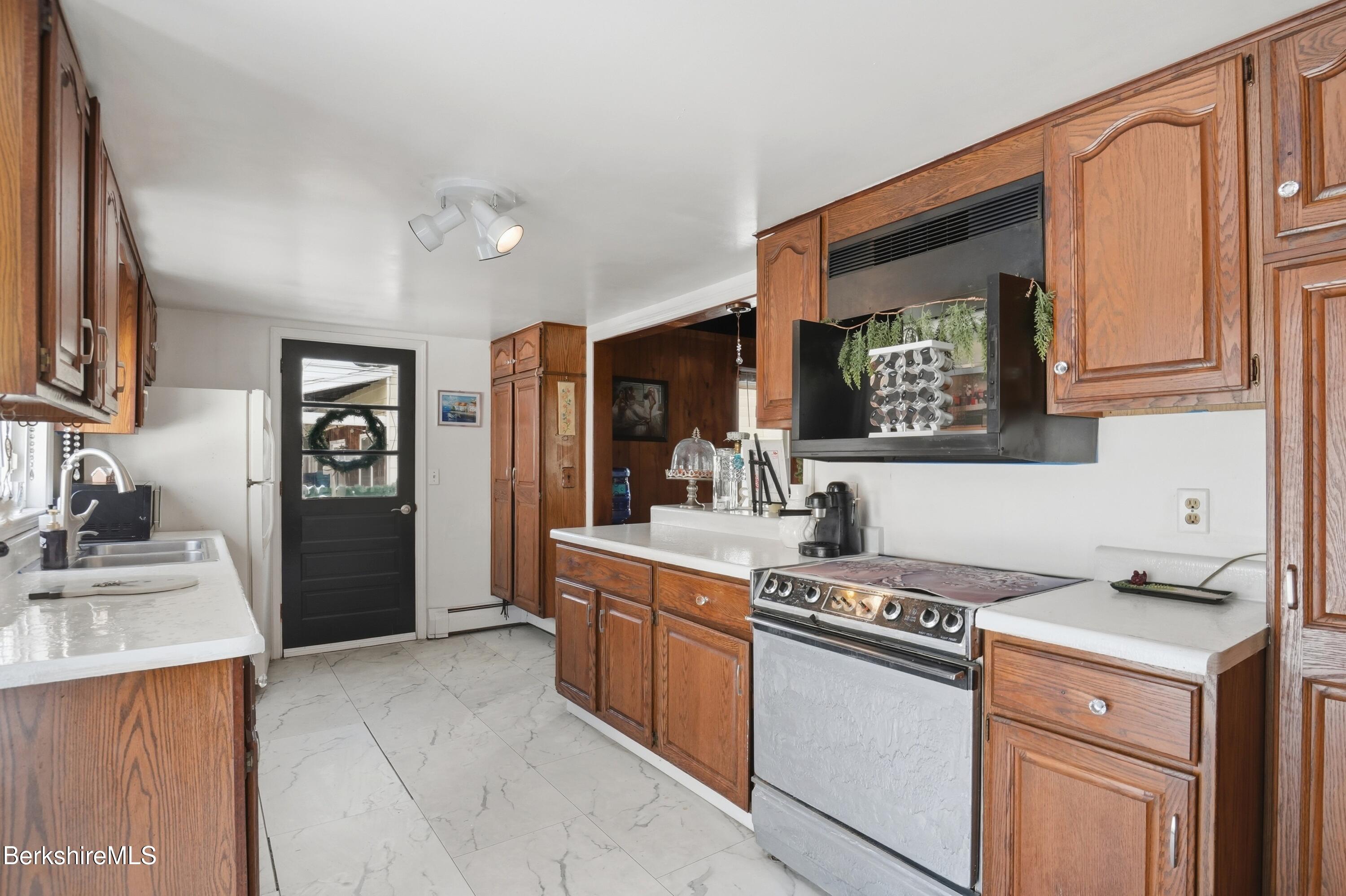 9 Lincoln Street Pittsfield, MA 01201 - Photo 7 of 44 a kitchen with a stove and a refrigerator