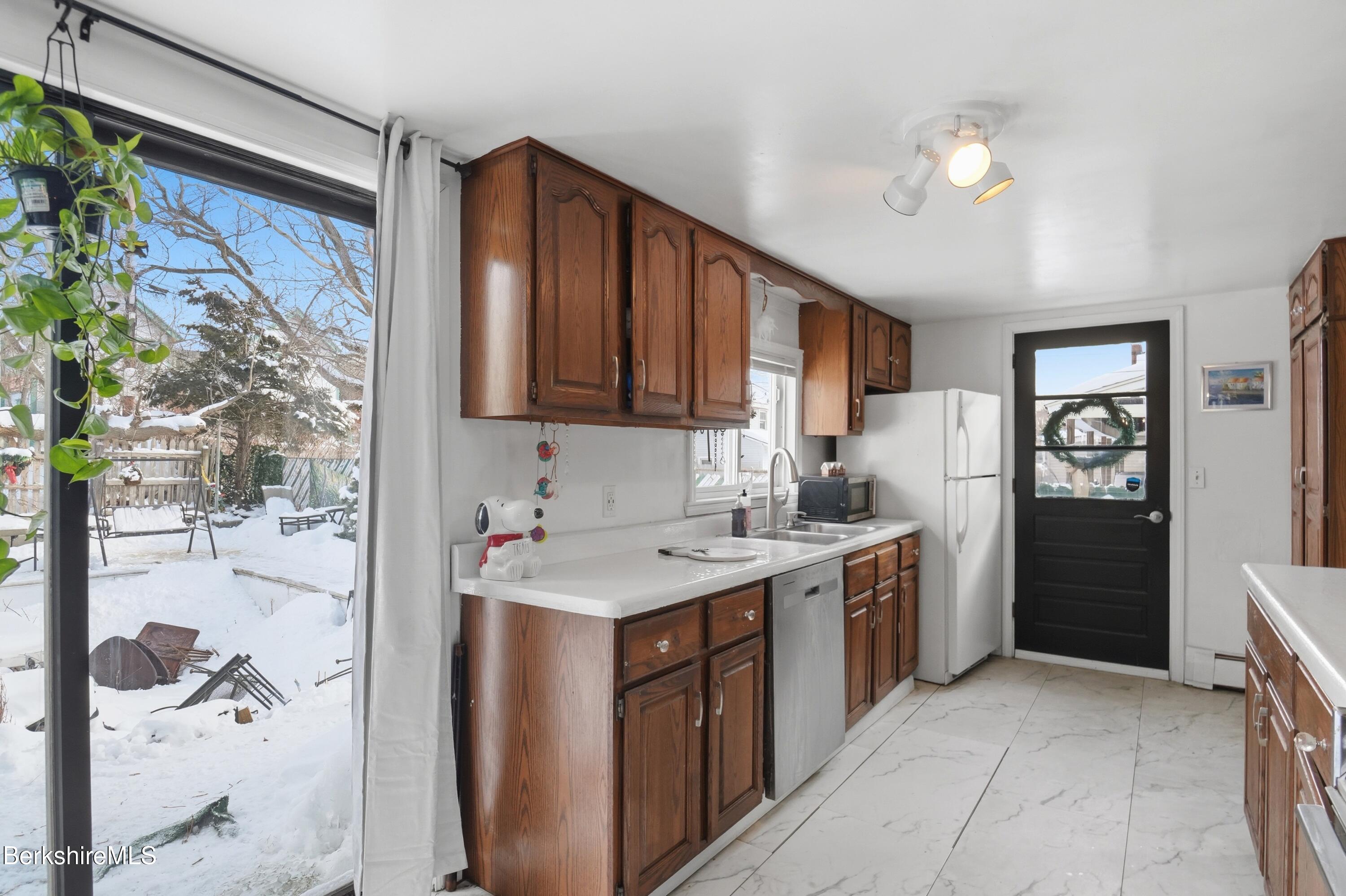9 Lincoln Street Pittsfield, MA 01201 - Photo 8 of 44 a kitchen with a sink stove and cabinets