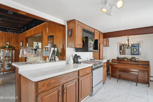 a large white kitchen with a large stove a sink and dishwasher