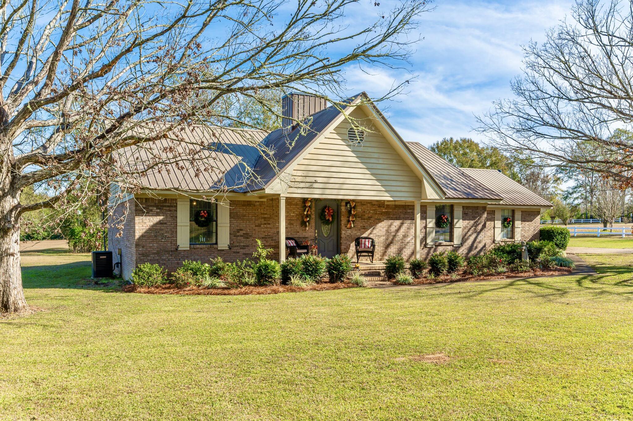 5811 Dairy Road Baker, FL 32531 - Photo 1 of 36 a front view of house with yard and green space