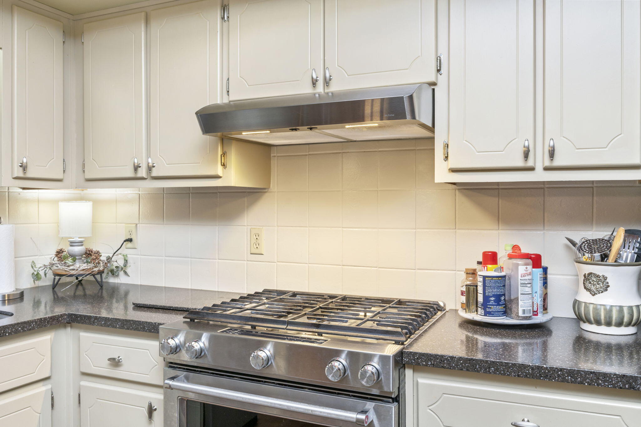 5811 Dairy Road Baker, FL 32531 - Photo 11 of 36 a kitchen with granite countertop a stove and cabinets