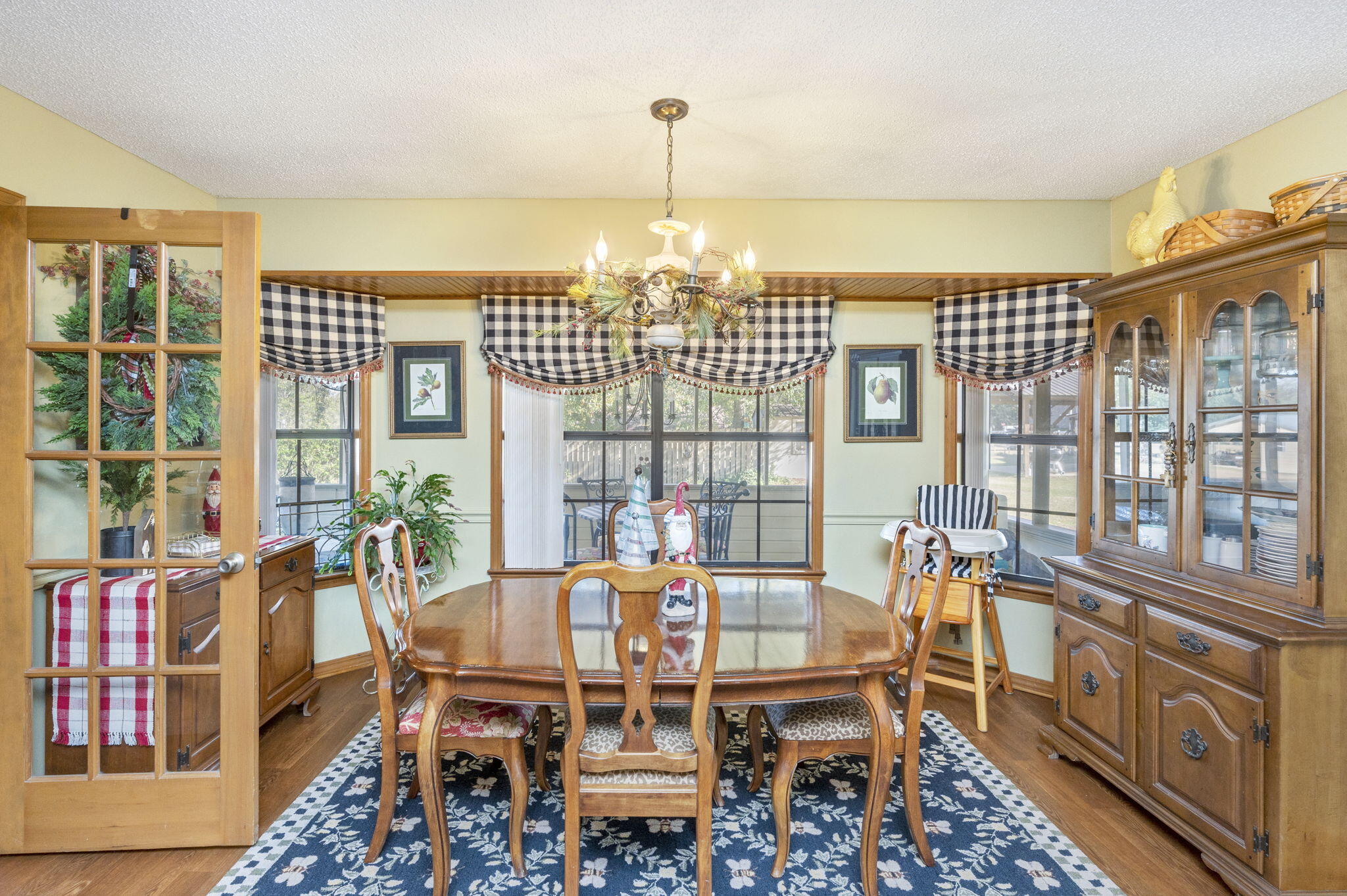 5811 Dairy Road Baker, FL 32531 - Photo 15 of 36 a dining room with furniture a chandelier and wooden floor