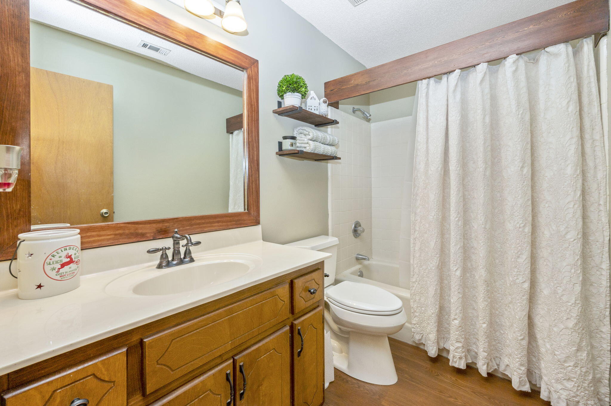5811 Dairy Road Baker, FL 32531 - Photo 24 of 36 a bathroom with a sink a toilet and shower curtain