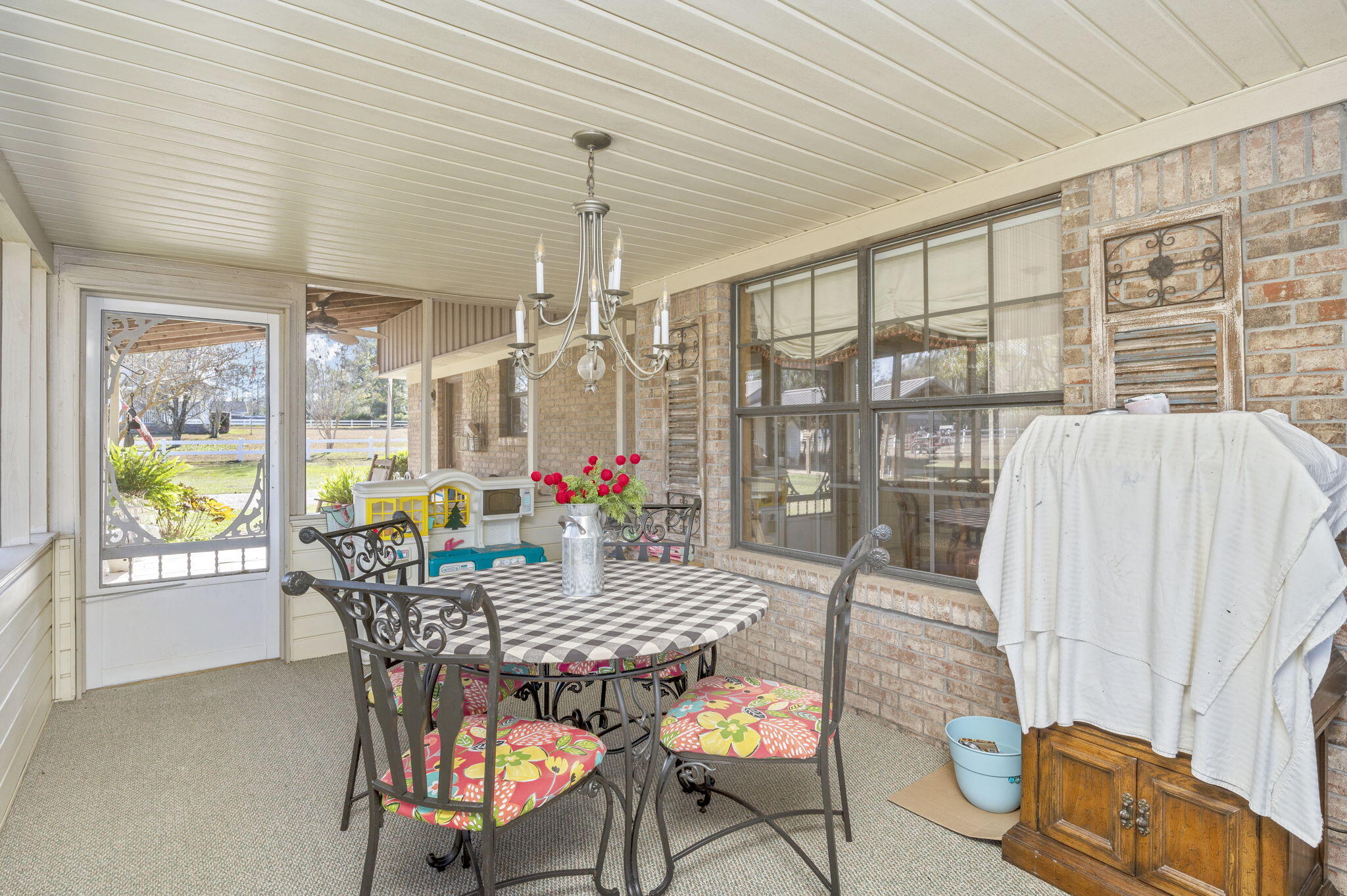 5811 Dairy Road Baker, FL 32531 - Photo 27 of 36 a outdoor dining space with furniture and chandelier
