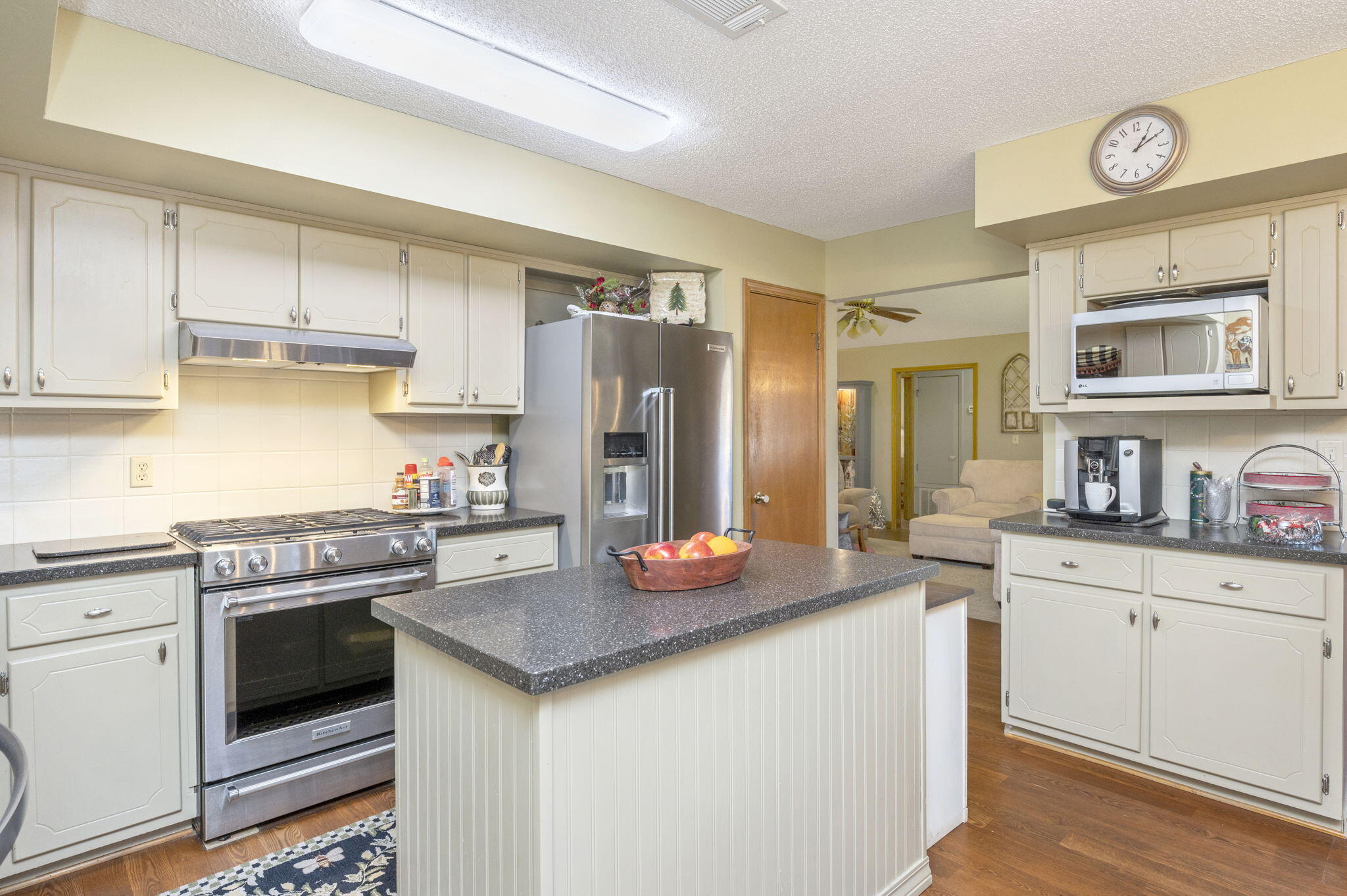 5811 Dairy Road Baker, FL 32531 - Photo 10 of 36 a kitchen with stainless steel appliances granite countertop a stove a sink dishwasher and a refrigerator with wooden cabinets