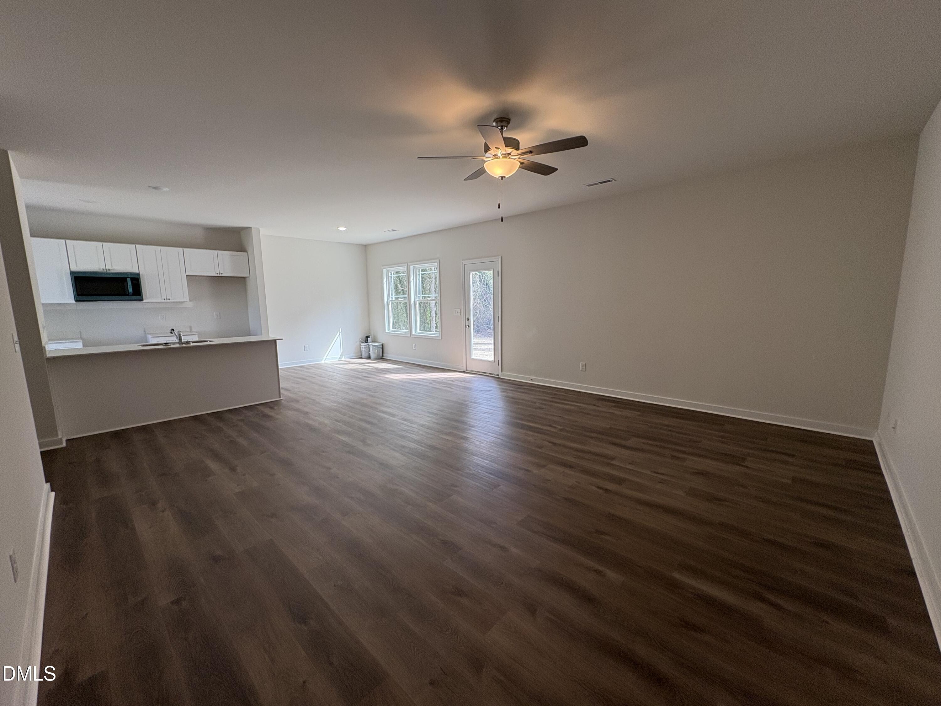 56 Jacobs Ridge Drive Four Oaks, NC 27524 - Photo 2 of 19 a view of a livingroom with wooden floor and ceiling fan