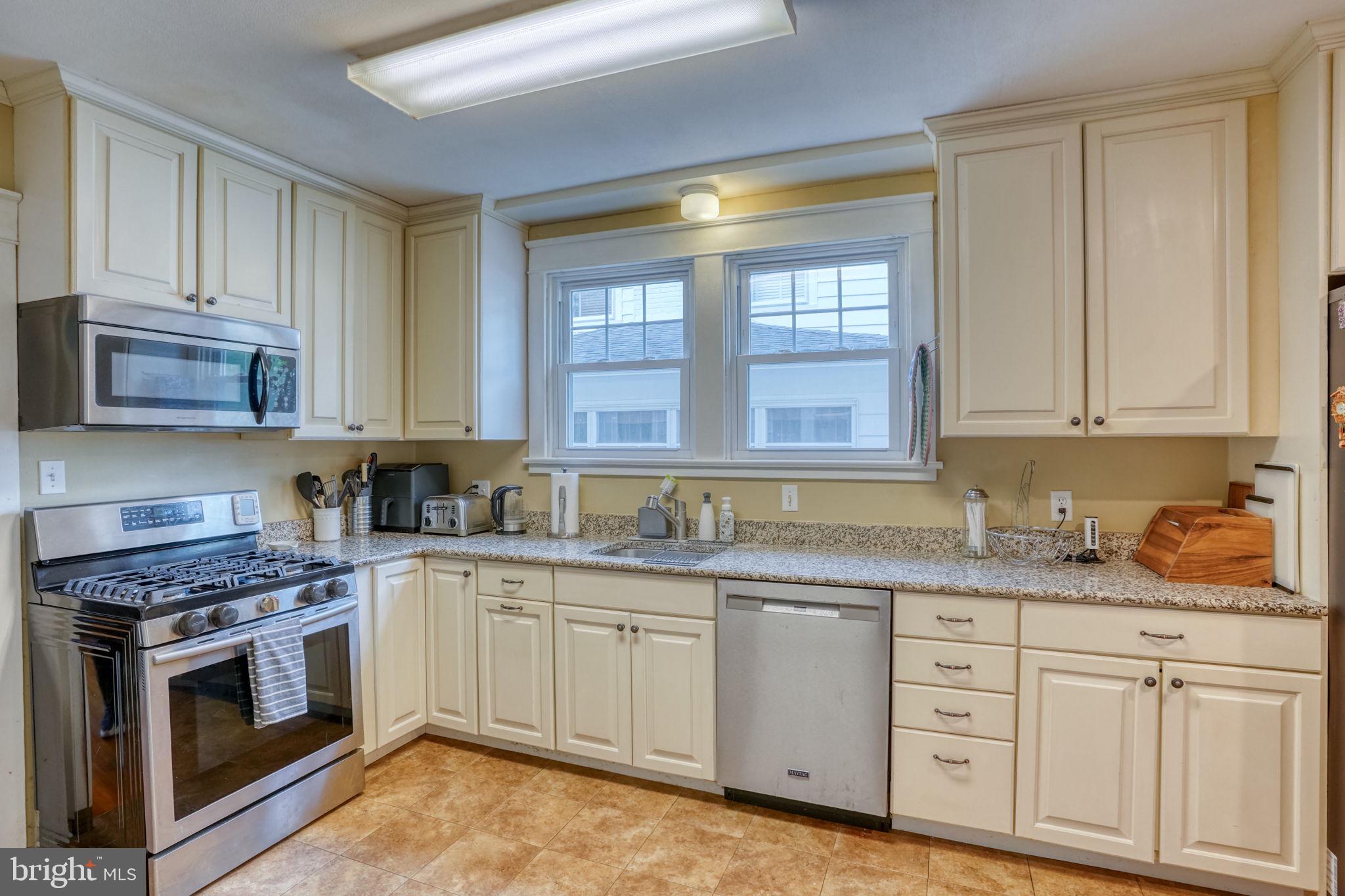 20 Rodney Road Dover, DE 19901 - Photo 25 of 58 a kitchen with granite countertop white cabinets and stainless steel appliances