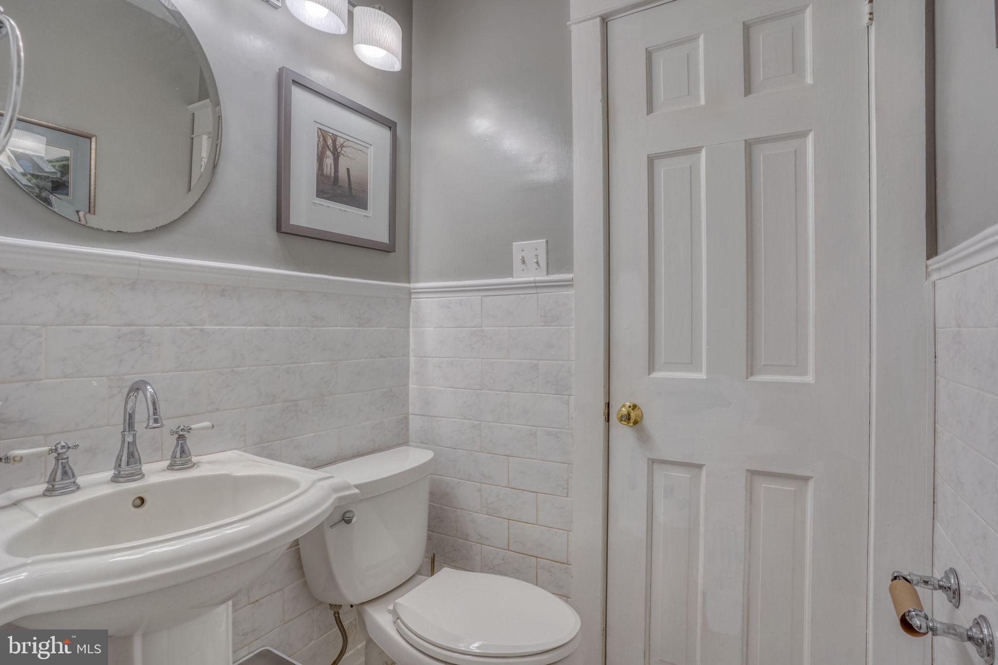 20 Rodney Road Dover, DE 19901 - Photo 33 of 58 a white toilet sitting next to a bathroom sink