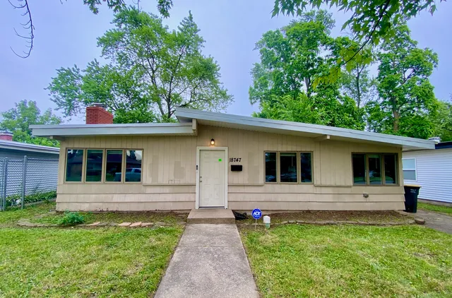 a front view of a house with yard