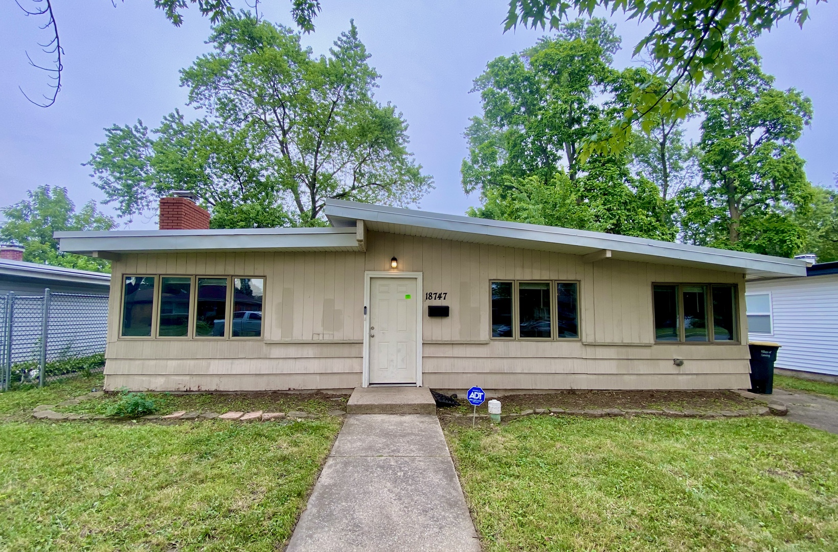 a front view of a house with yard