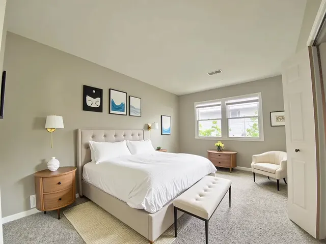 a bedroom with a bed and a couch