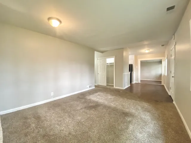 an empty room with a empty space and windows