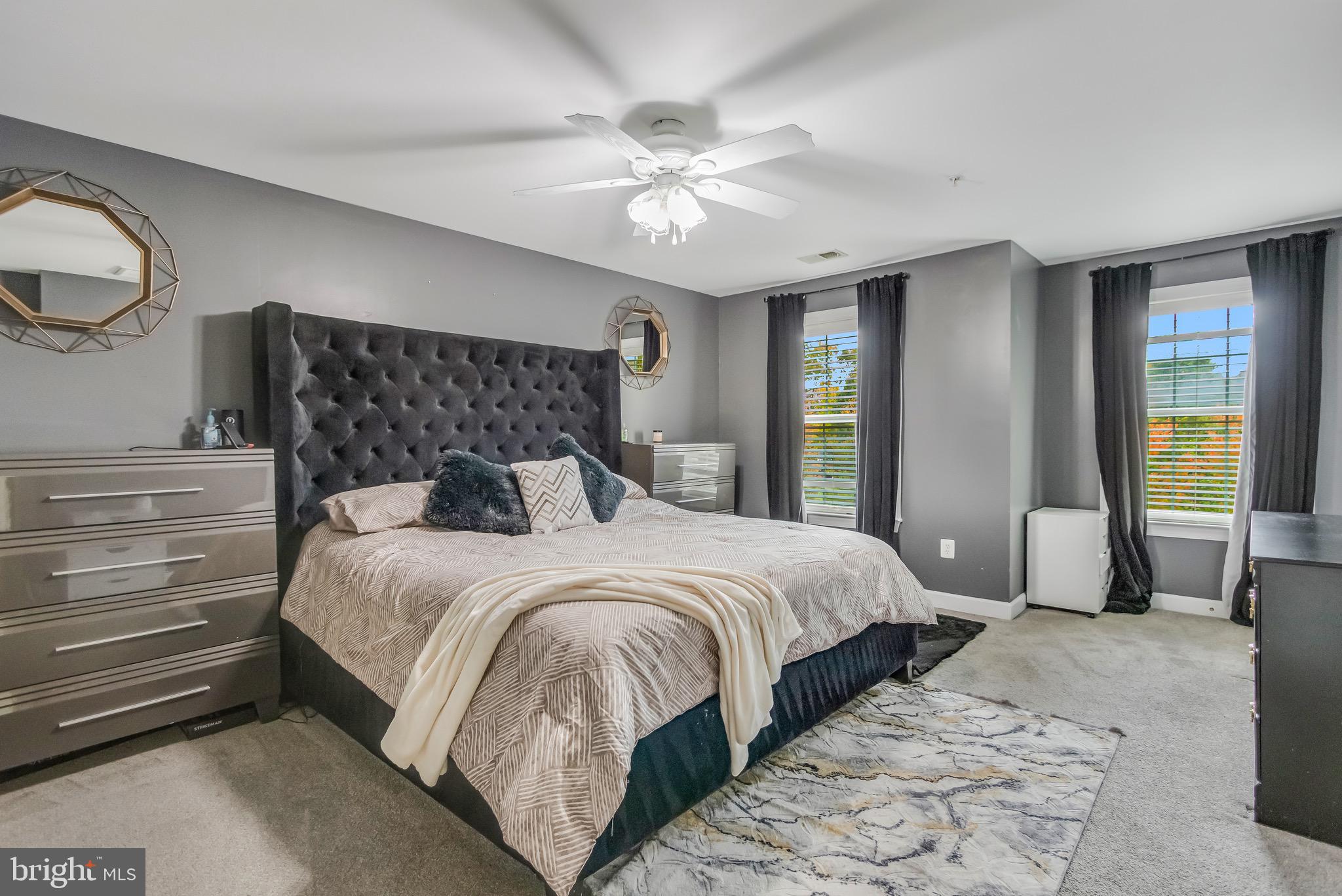 16607 Mannington Road Accokeek, MD 20607 - Photo 15 of 32 a bedroom with a large bed and a chandelier