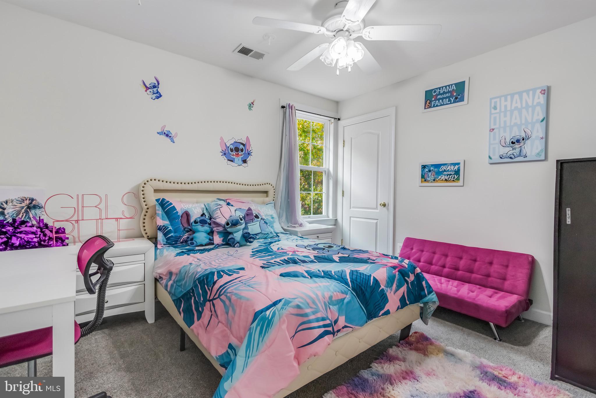 16607 Mannington Road Accokeek, MD 20607 - Photo 17 of 32 a bedroom with a bed and a chandelier