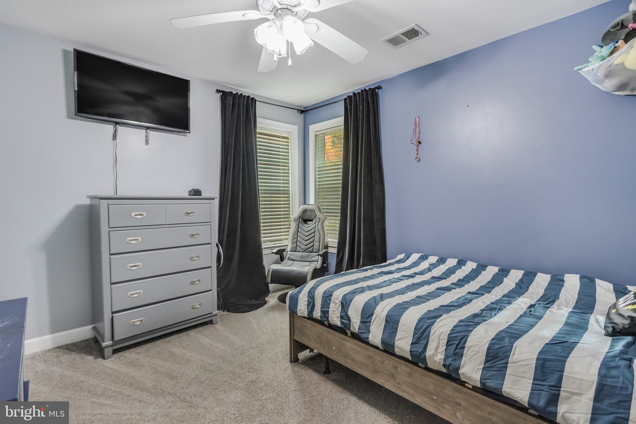 16607 Mannington Road Accokeek, MD 20607 - Photo 19 of 32 a bedroom with a bed and a flat screen tv