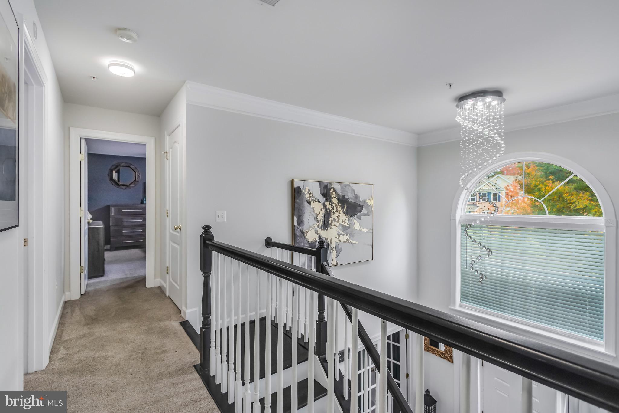 16607 Mannington Road Accokeek, MD 20607 - Photo 20 of 32 a view of a hallway to a livingroom with wooden floor and a window