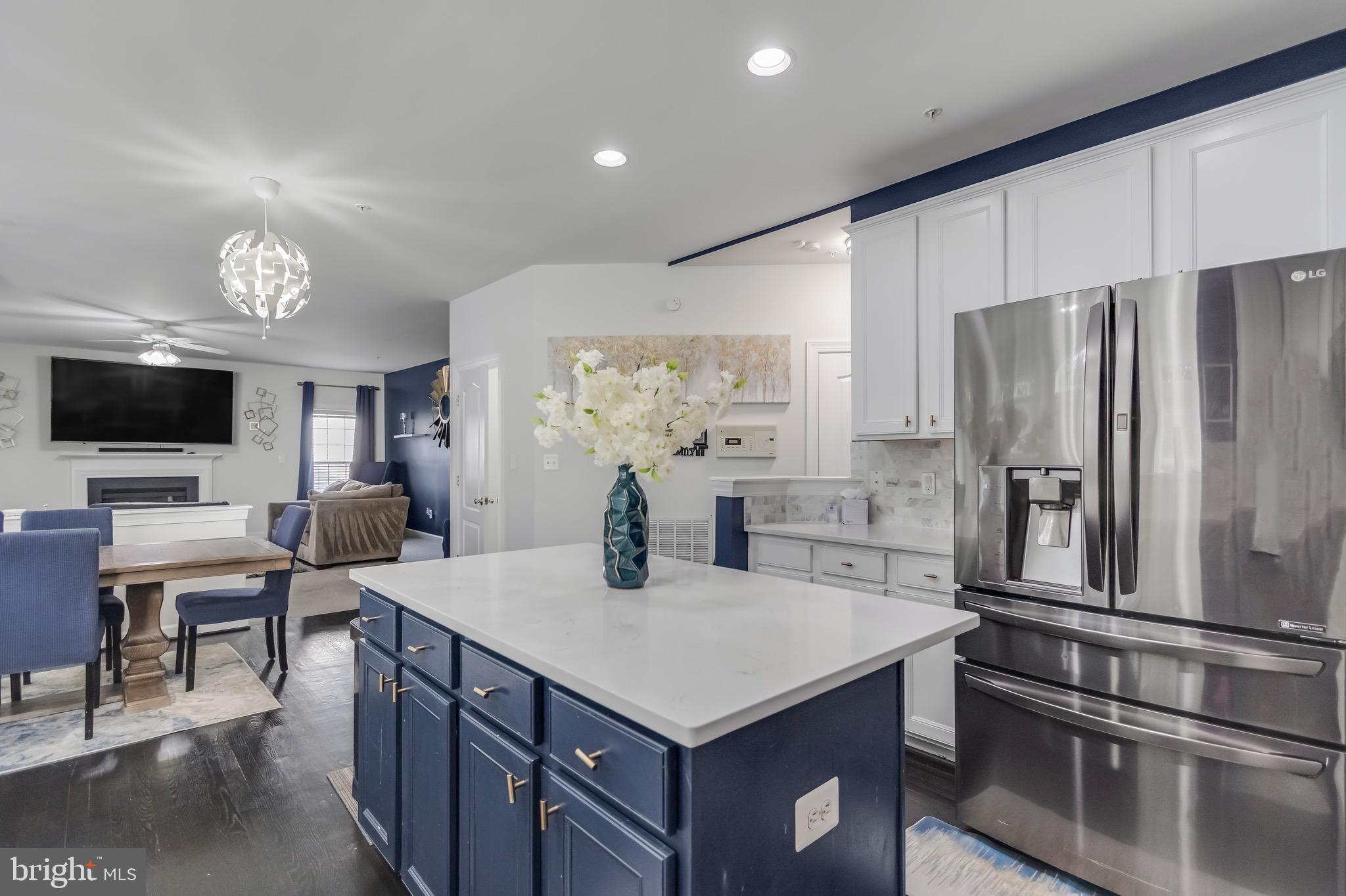 16607 Mannington Road Accokeek, MD 20607 - Photo 5 of 32 a kitchen with stainless steel appliances a table chairs and a refrigerator