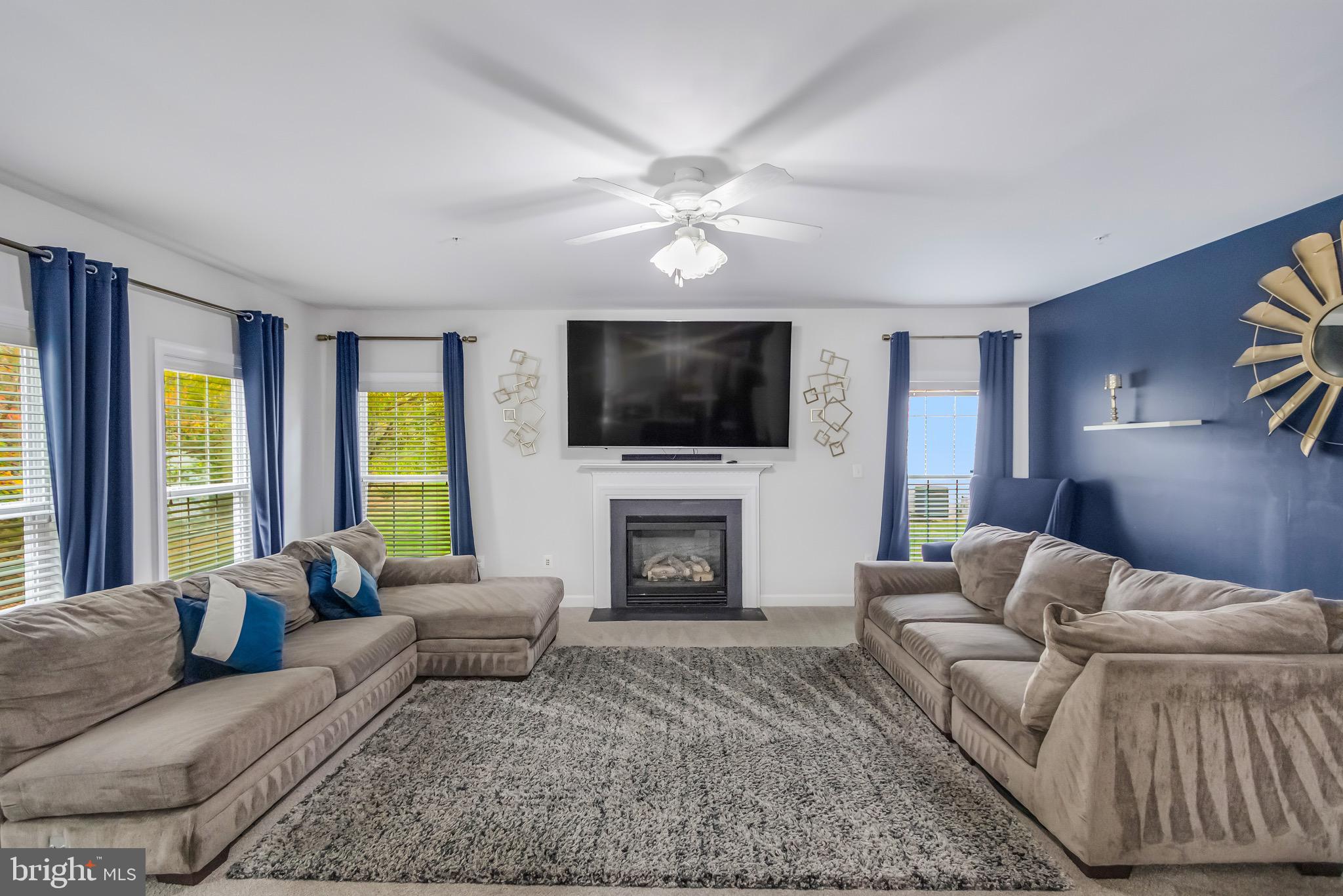 16607 Mannington Road Accokeek, MD 20607 - Photo 10 of 32 a living room with furniture a fireplace and a flat screen tv