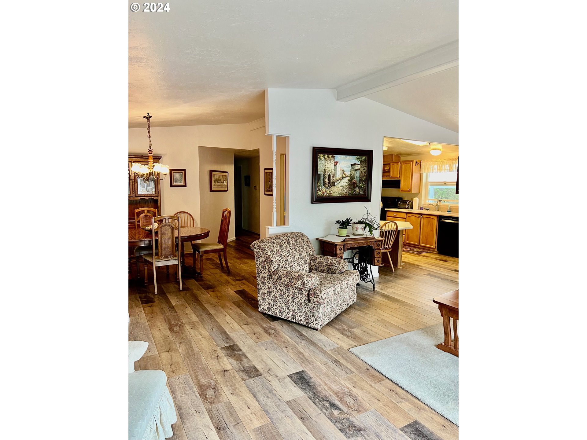 1601 Rhododendron Drive, Unit 694 Florence, OR 97439 - Photo 10 of 32 a living room with furniture and a flat screen tv