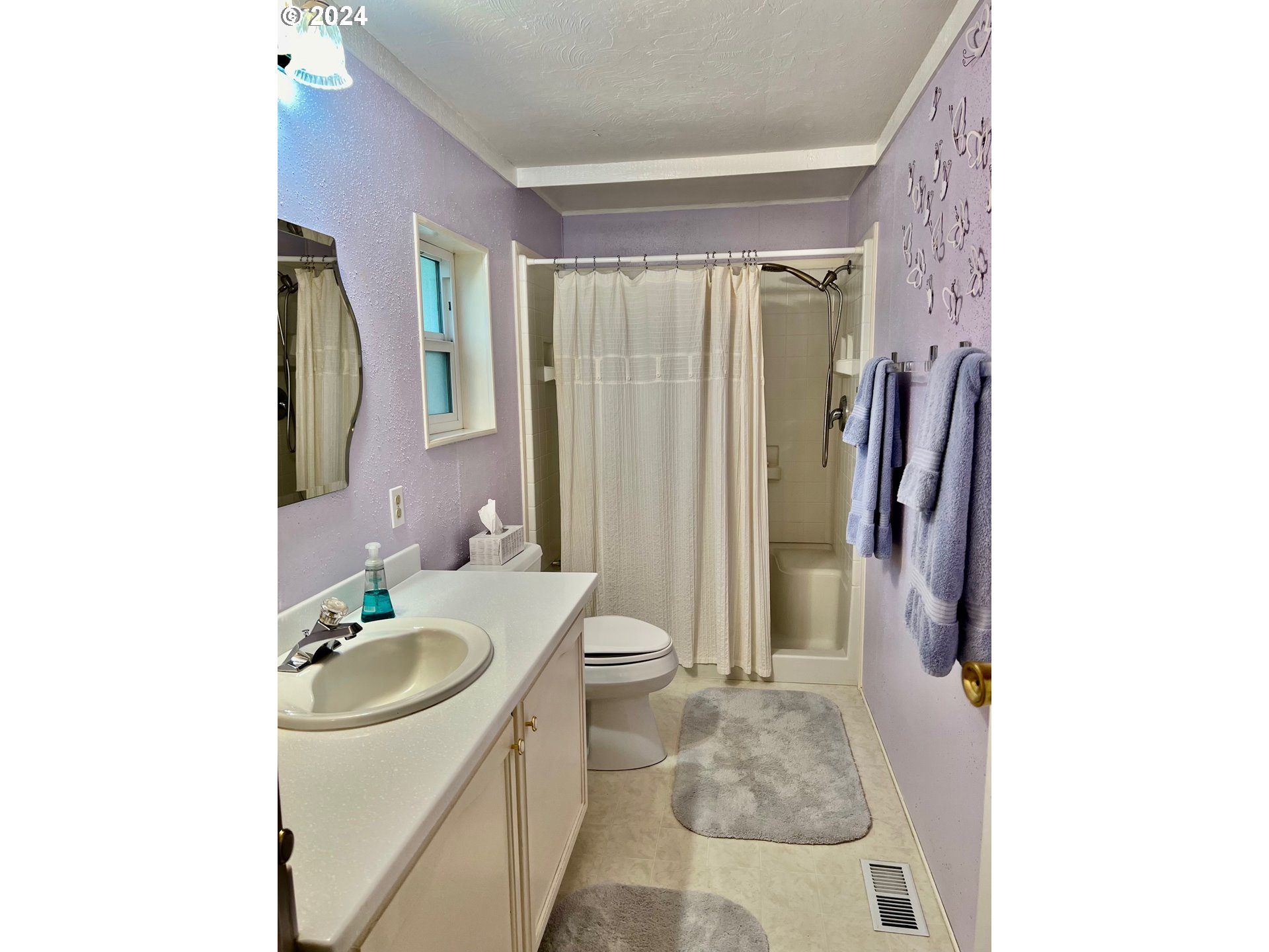 1601 Rhododendron Drive, Unit 694 Florence, OR 97439 - Photo 13 of 32 a bathroom with a sink a toilet and shower
