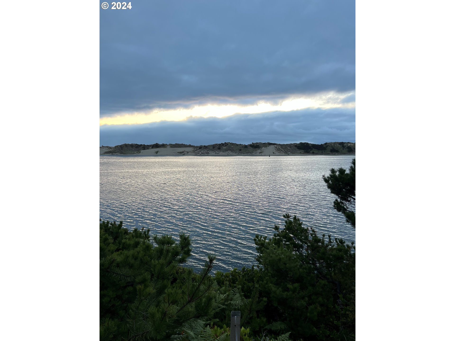 1601 Rhododendron Drive, Unit 694 Florence, OR 97439 - Photo 19 of 32 a view of a lake from a balcony