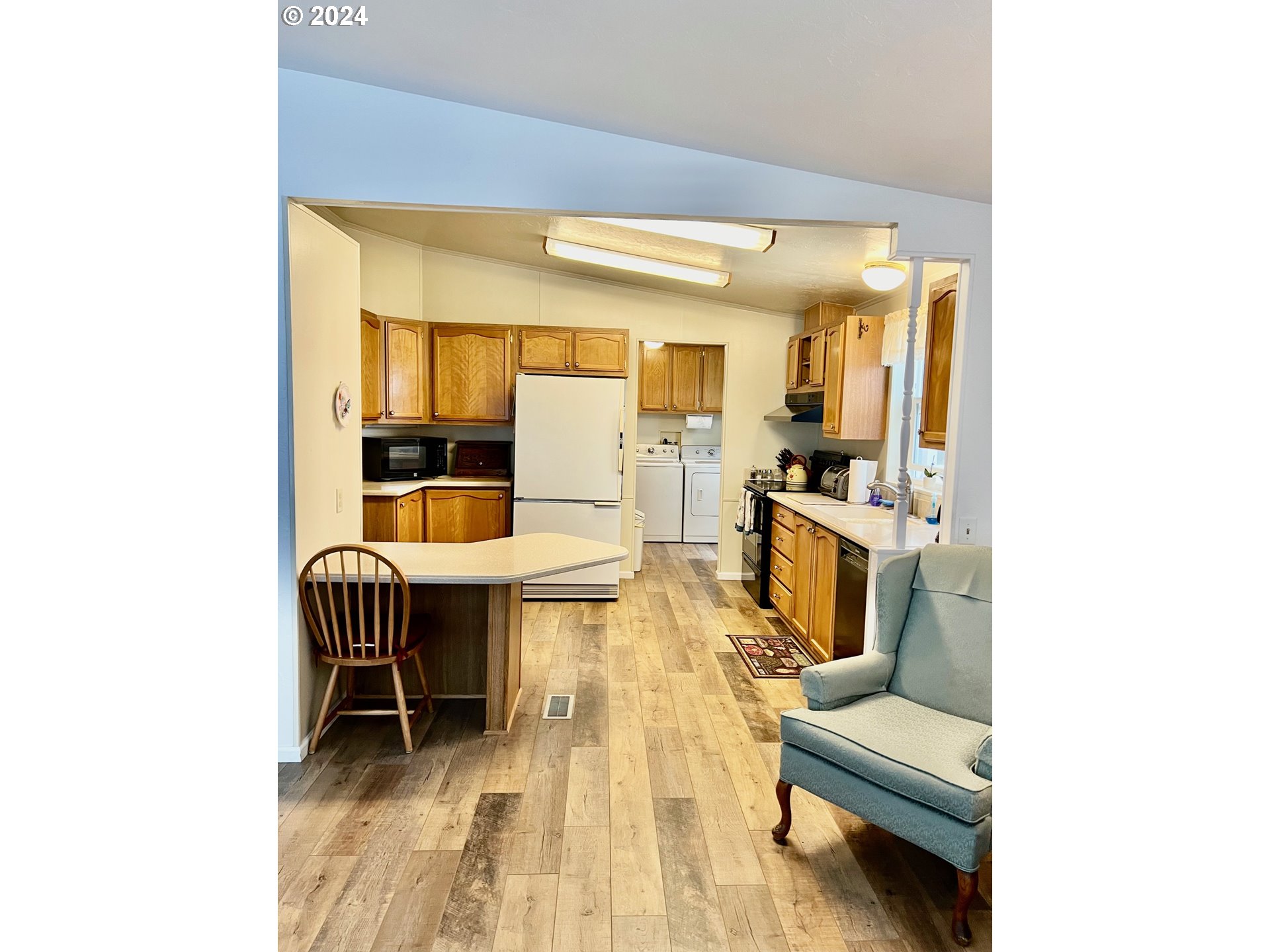 1601 Rhododendron Drive, Unit 694 Florence, OR 97439 - Photo 2 of 32 a living room with furniture and a table