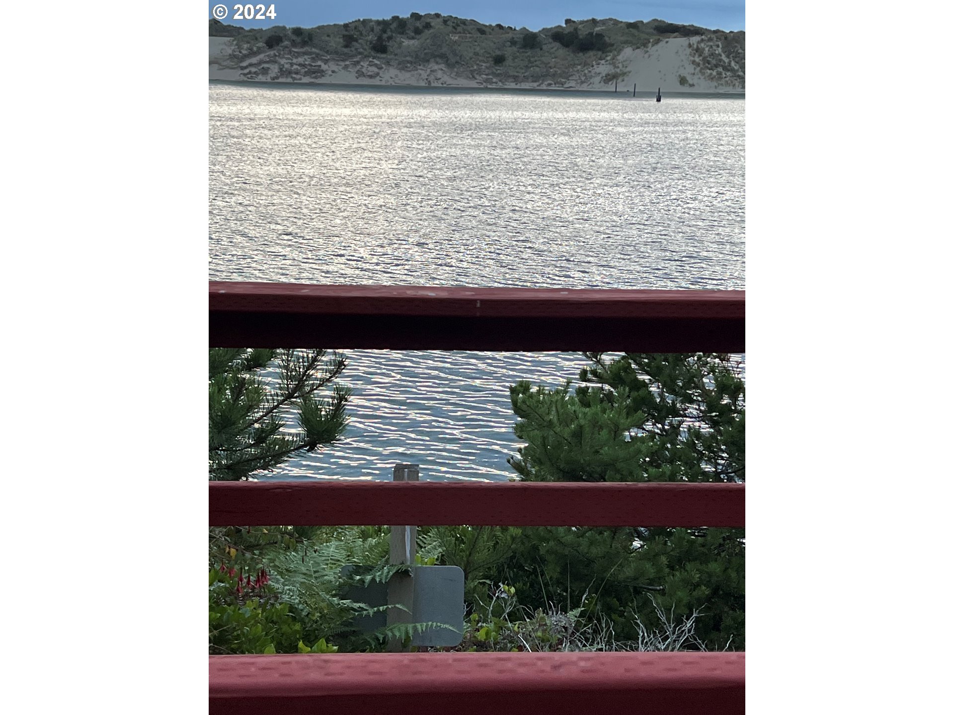 1601 Rhododendron Drive, Unit 694 Florence, OR 97439 - Photo 21 of 32 a view of a lake from a window