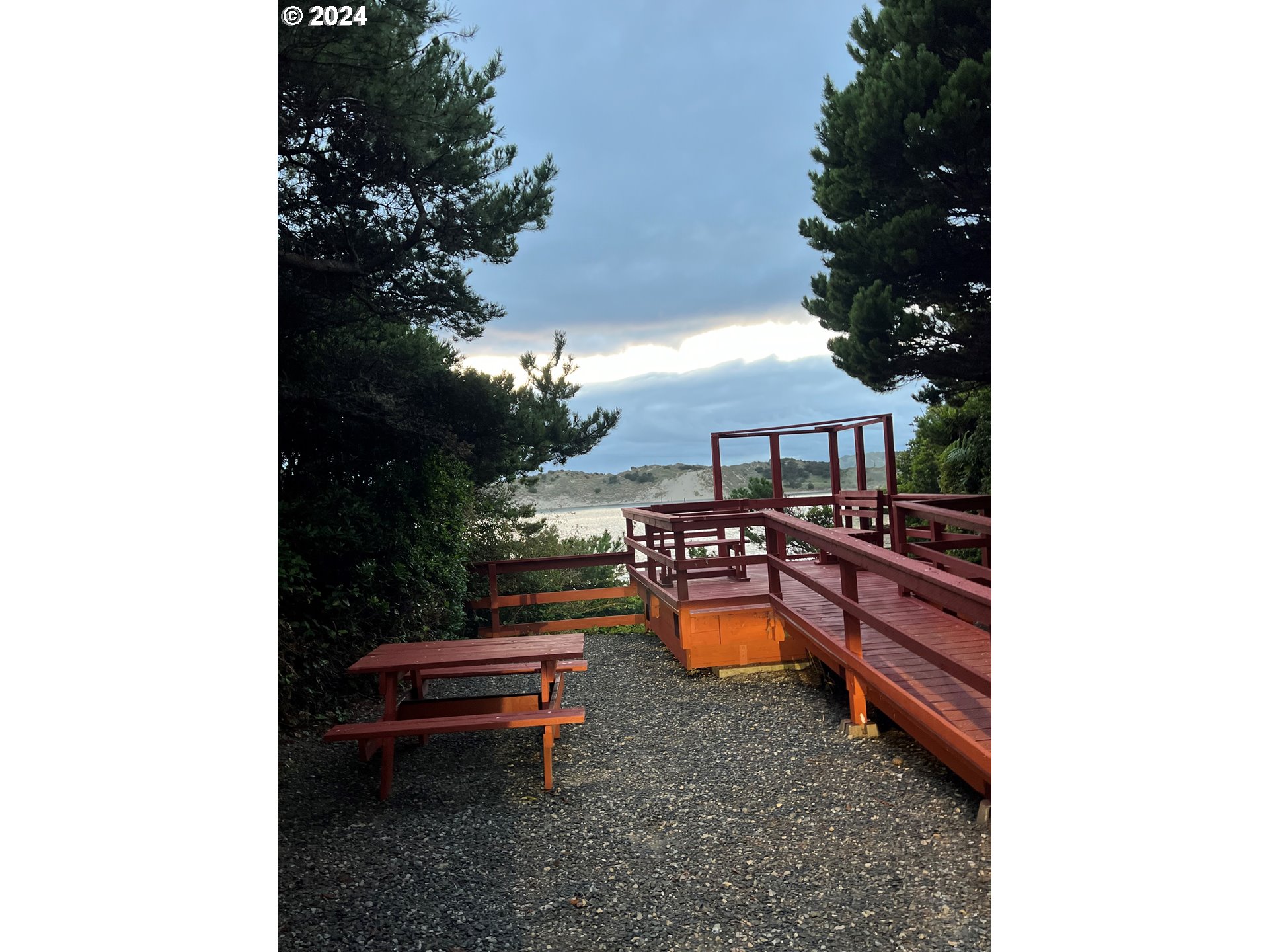 1601 Rhododendron Drive, Unit 694 Florence, OR 97439 - Photo 23 of 32 a backyard of a house with outdoor seating
