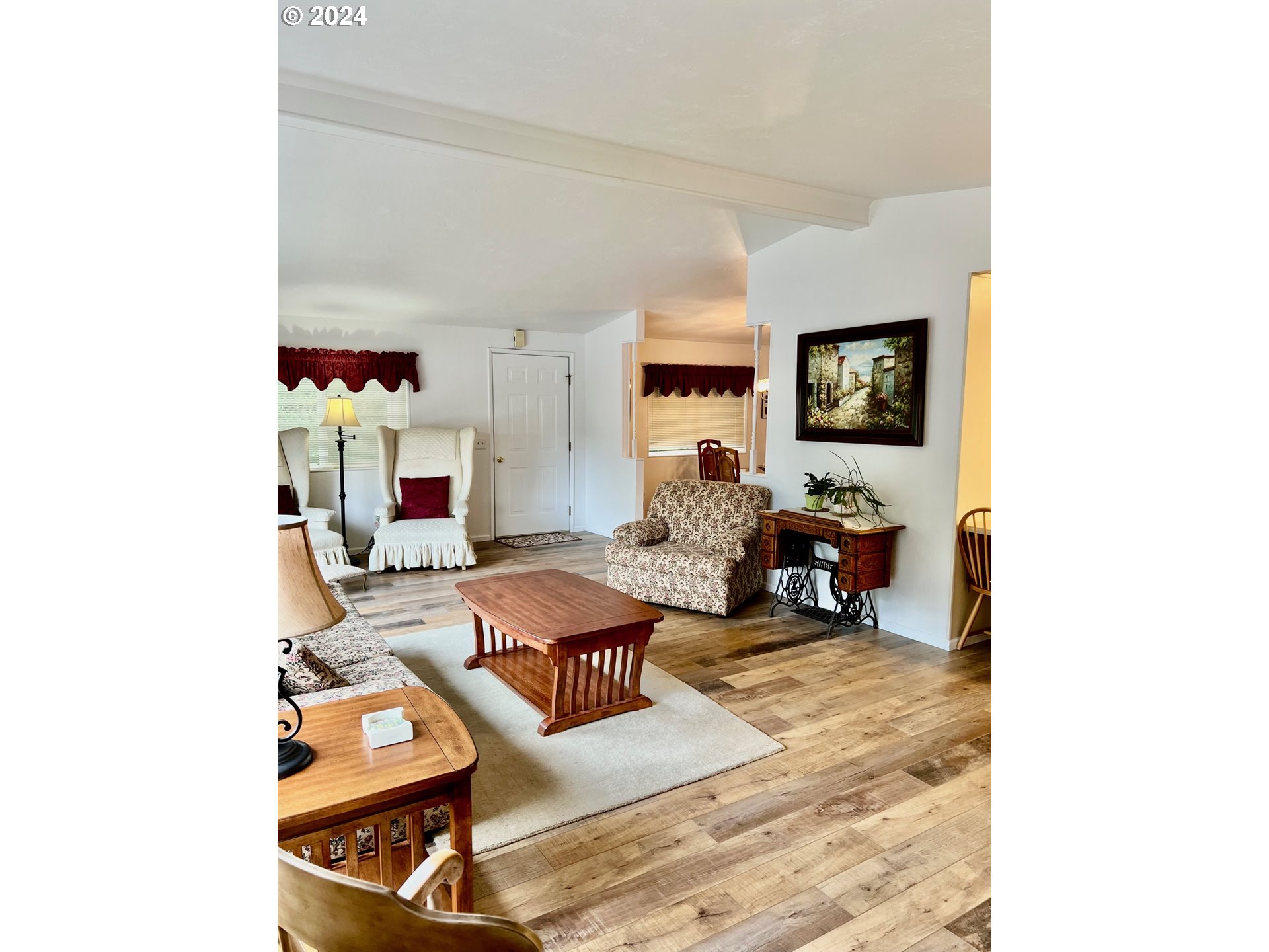 1601 Rhododendron Drive, Unit 694 Florence, OR 97439 - Photo 7 of 32 a living room with furniture and a flat screen tv