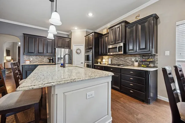 a kitchen with a stove a refrigerator and a sink