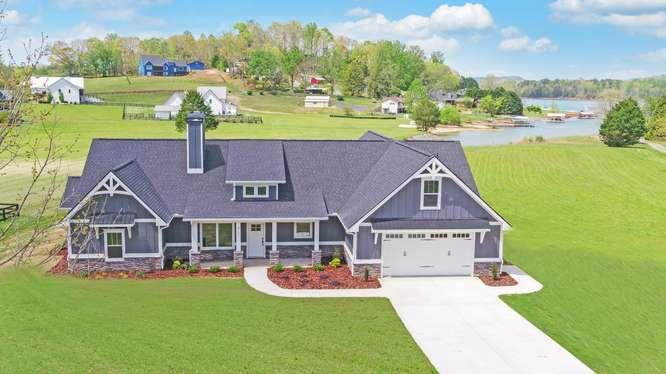317 Bell Creek Cove Road Hiawassee, GA 30546 - Photo 1 of 74 a front view of a house with garden