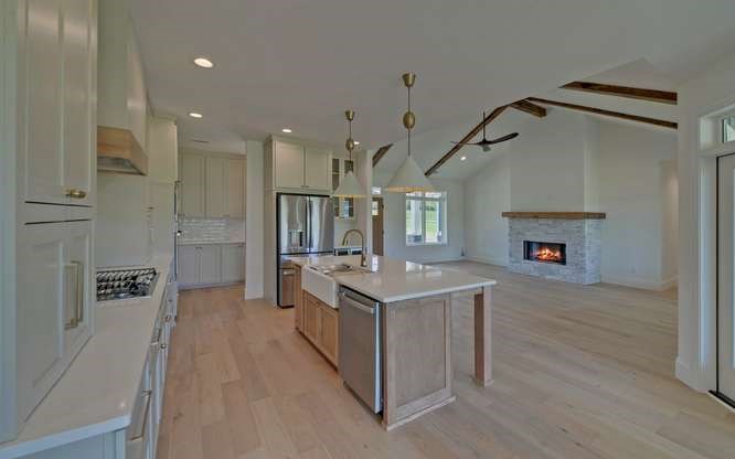317 Bell Creek Cove Road Hiawassee, GA 30546 - Photo 11 of 74 a open kitchen with kitchen island a stove a sink and a refrigerator