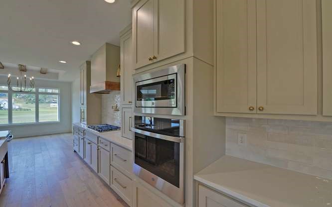 317 Bell Creek Cove Road Hiawassee, GA 30546 - Photo 12 of 74 a kitchen with stainless steel appliances a stove and a refrigerator