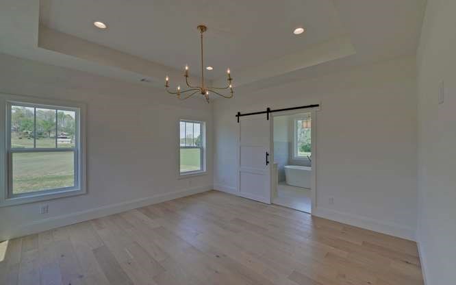 317 Bell Creek Cove Road Hiawassee, GA 30546 - Photo 20 of 74 an empty room with wooden floor and windows