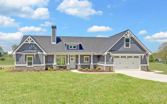 317 Bell Creek Cove Road Hiawassee, GA 30546 - Photo 2 of 74 a front view of a house with a yard table and chairs