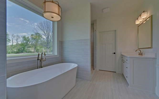 317 Bell Creek Cove Road Hiawassee, GA 30546 - Photo 24 of 74 a bathroom with a sink a bathtub and window