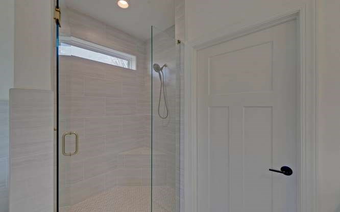 317 Bell Creek Cove Road Hiawassee, GA 30546 - Photo 27 of 74 a bathroom with a glass shower door