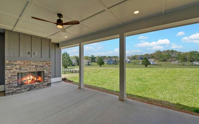 317 Bell Creek Cove Road Hiawassee, GA 30546 - Photo 49 of 74 a view of an empty room with a fireplace and a floor to ceiling window
