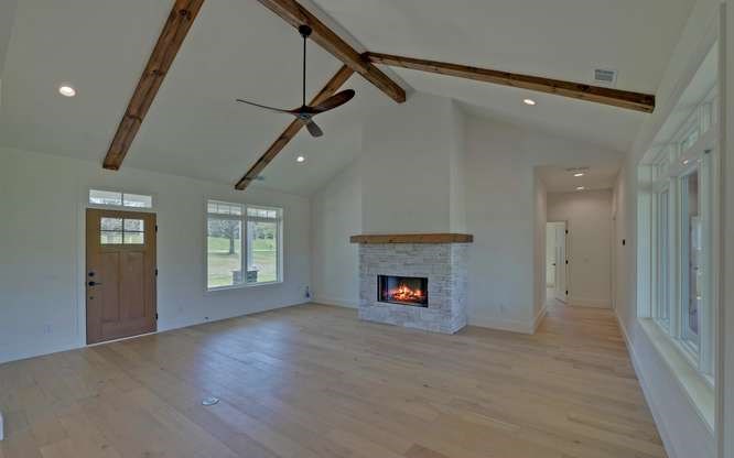 317 Bell Creek Cove Road Hiawassee, GA 30546 - Photo 6 of 74 an empty room with windows and fireplace