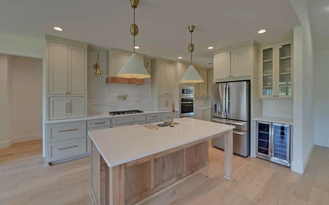 317 Bell Creek Cove Road Hiawassee, GA 30546 - Photo 10 of 74 a kitchen with kitchen island a stove a sink and a refrigerator