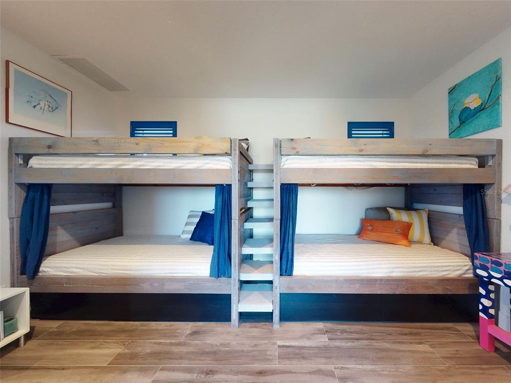 901 Sheepshead Avenue New Smyrna Beach, FL 32169 - Photo 11 of 64 a bedroom with two bunk beds and a desk