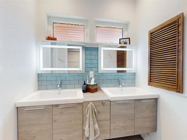 a white bath tub sitting in a bathroom next to a window