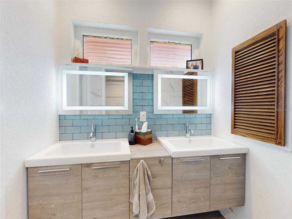 901 Sheepshead Avenue New Smyrna Beach, FL 32169 - Photo 16 of 64 a bathroom with a sink and a mirror