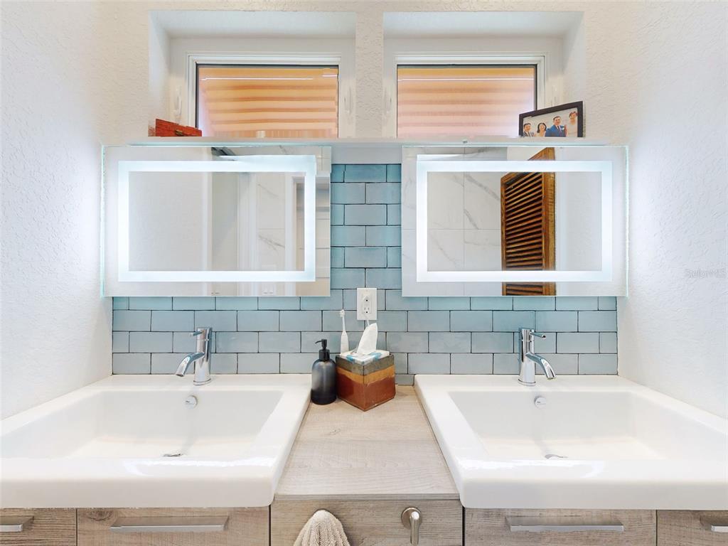 901 Sheepshead Avenue New Smyrna Beach, FL 32169 - Photo 18 of 64 a bathroom with a sink and a bathtub