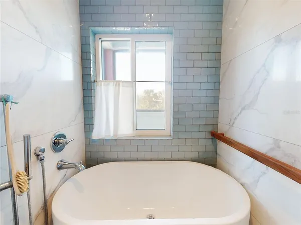 a view of a hallway with wooden floor and a living room