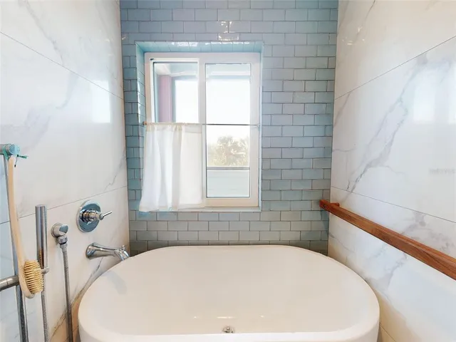 a view of a hallway with wooden floor and a living room